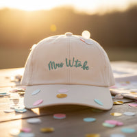 Load image into Gallery viewer, Beige cap with the words Mrs W to Be embroidered on the front in turquoise thread.
