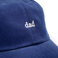 Load image into Gallery viewer, Close up of Navy cap with the word Dad embroidered in white thread. 
