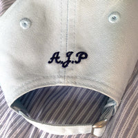 Load image into Gallery viewer, navy canvas cap with an embroidered initials on the back.
